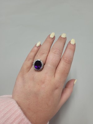 Lot 116 - AN AMETHYST AND DIAMOND RING, the oval...