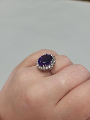 Lot 116 - AN AMETHYST AND DIAMOND RING, the oval...