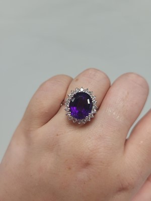 Lot 116 - AN AMETHYST AND DIAMOND RING, the oval...