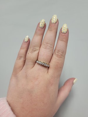 Lot 121 - A VINTAGE SEVEN STONE DIAMOND RING, the...