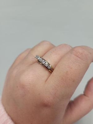 Lot 121 - A VINTAGE SEVEN STONE DIAMOND RING, the...