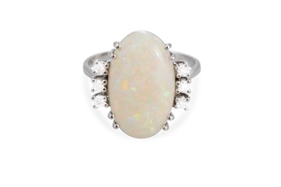 Lot 122 - AN OPAL AND DIAMOND RING, the oval opal to a...