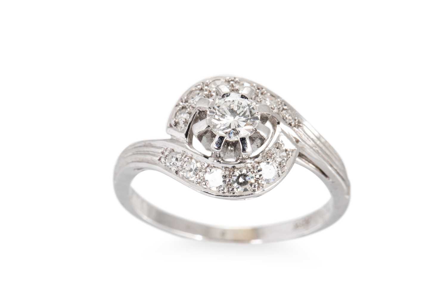 Lot 123 - A DIAMOND CLUSTER RING, of twist design, 14ct...