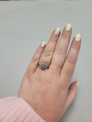 Lot 123 - A DIAMOND CLUSTER RING, of twist design, 14ct...