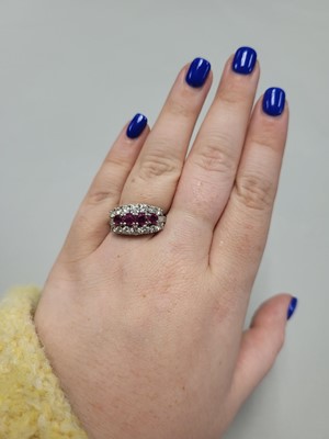 Lot 67 - A VINTAGE THREE ROWED DIAMOND AND RUBY BAND...