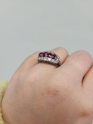 Lot 67 - A VINTAGE THREE ROWED DIAMOND AND RUBY BAND...