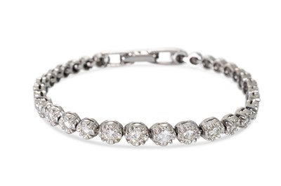 Lot 174 - A GRADUATED DIAMOND BRACELET, illusion setting...