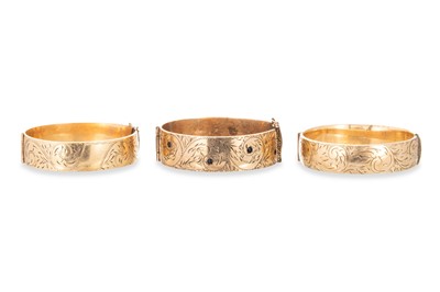 Lot 196 - THREE VINTAGE GOLD PLATED BANGLES, hinged