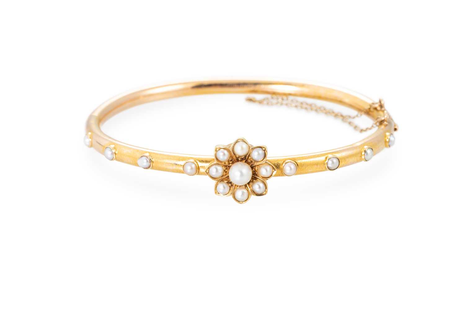 Lot 30 - A LATE VICTORIAN PEARL SET BANGLE, with...