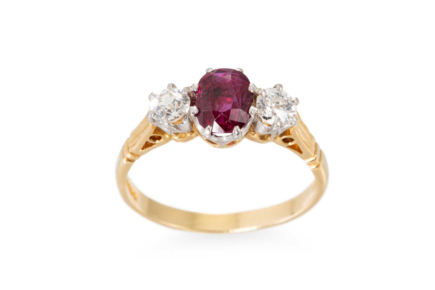 Lot 95 - A RUBY AND DIAMOND THREE STONE RING, the oval...