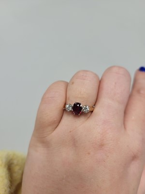 Lot 95 - A RUBY AND DIAMOND THREE STONE RING, the oval...
