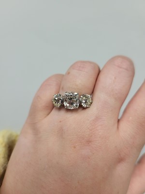 Lot 229 - AN OLD CUT DIAMOND THREE STONE RING, the...