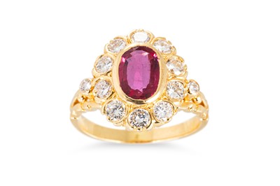 Lot 144 - A RUBY AND DIAMOND CLUSTER RING, the central...