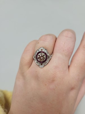 Lot 54 - A CHAMPAGNE DIAMOND AND RUBY TARGET RING, the...