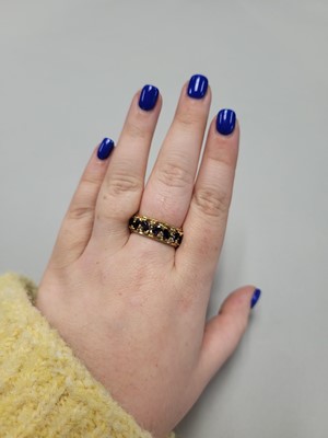 Lot 55 - A DIAMOND AND SAPPHIRE SET FULL BAND RING, the...