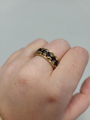 Lot 55 - A DIAMOND AND SAPPHIRE SET FULL BAND RING, the...