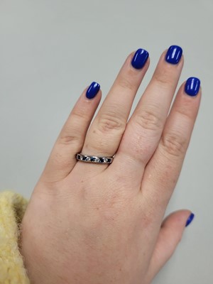 Lot 24 - A DIAMOND AND SAPPHIRE SET BAND RING, the...
