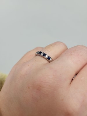 Lot 24 - A DIAMOND AND SAPPHIRE SET BAND RING, the...