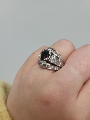Lot 25 - A GARNET AND DIAMOND RETRO STYLE CLUSTER RING,...