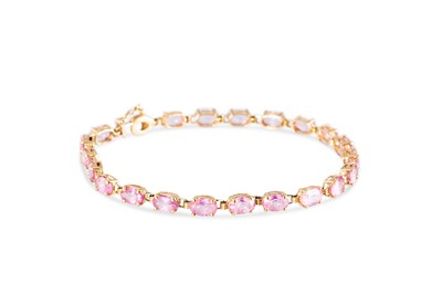 Lot 215 - A PINK TOPAZ SET BRACELET, the oval topaz...