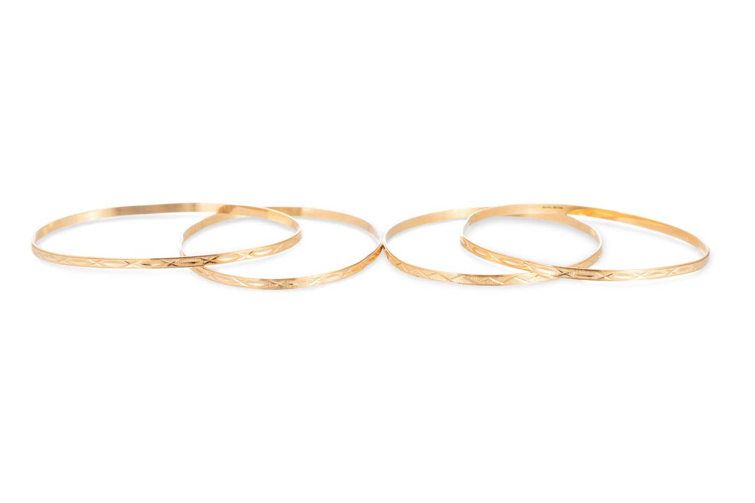 Lot 43 - FOUR 18CT YELLOW GOLD BANGLES, bright cut...