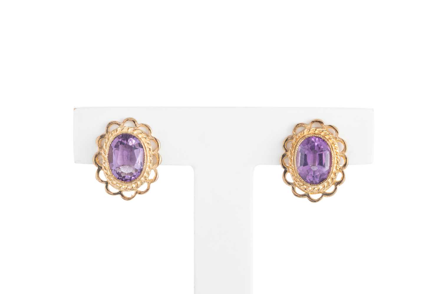 Lot 11 - A PAIR OF AMETHYST STUD EARRINGS, the oval...