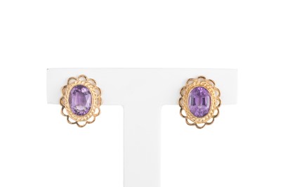 Lot 11 - A PAIR OF AMETHYST STUD EARRINGS, the oval...