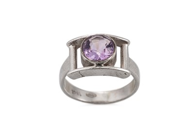 Lot 102 - A NIAMH UTSCH AMETHYST RING, the round cut...