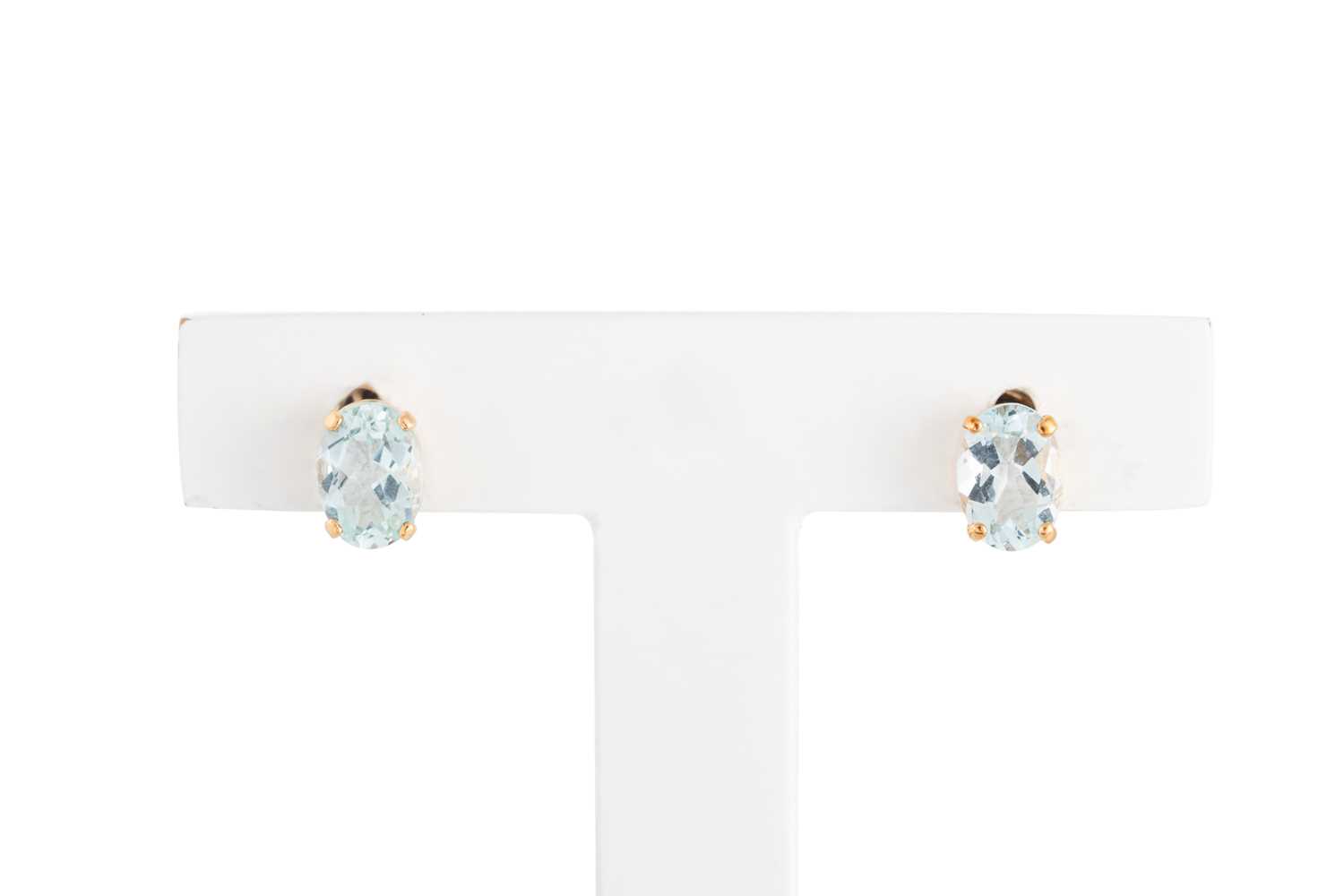 Lot 61 - A PAIR OF AQUAMARINE STUD EARRINGS, the oval...