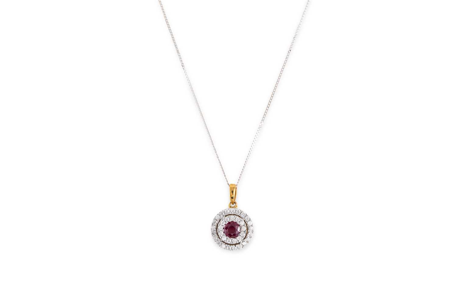 Lot 82 - A DIAMOND AND RUBY PENDANT, the round ruby to...