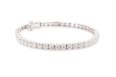 Lot 349 - A DIAMOND SET LINE BRACELET, the round...
