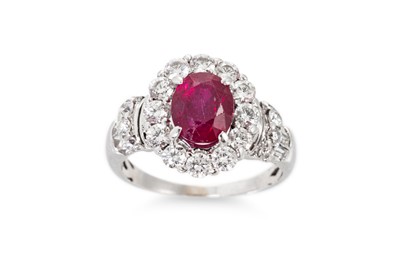 Lot 4 - A RUBY AND DIAMOND CLUSTER RING, the oval ruby...