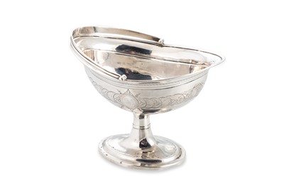 Lot 481 - A GEORGE III IRISH SILVER HELMET SHAPED SWING...