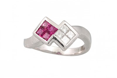 Lot 175 - A DIAMOND AND RUBY CLUSTER RING, set with...