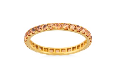 Lot 155 - AN ORANGE SAPPHIRE FULL ETERNITY RING, mounted...