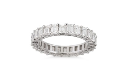Lot 242 - AN EMERALD CUT DIAMOND FULL ETERNITY RING,...