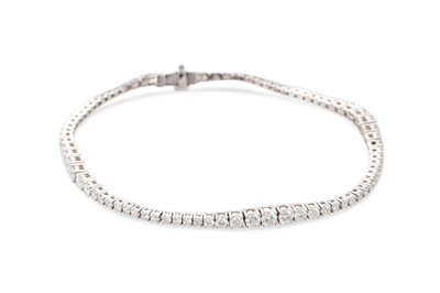 Lot 243 - A DIAMOND LINE BRACELET, the brilliant cut...