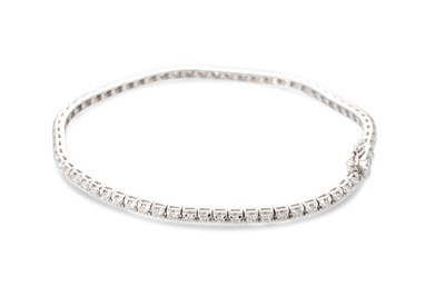 Lot 244 - A DIAMOND LINE BRACELET, the brilliant cut...