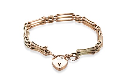 Lot 419 - A 9CT GOLD THREE BAR GATE BRACELET, with...