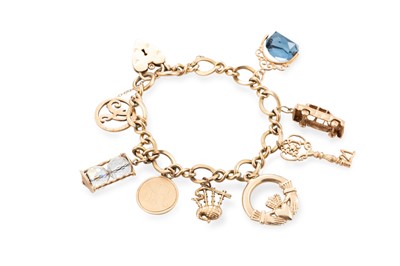 Lot 420 - A 9CT GOLD CHARM BRACELET, with various charms,...