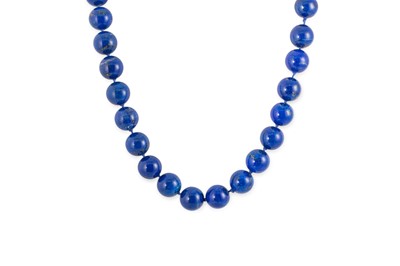 Lot 181 - A LAPIS LAZULI BEADED NECKLACE, to an 18ct...