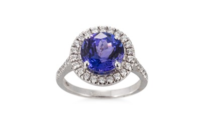 Lot 200 - A TANZANITE AND DIAMOND RING, the round...