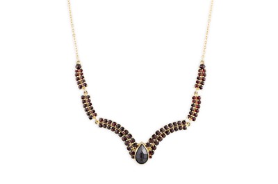 Lot 174 - A GARNET SET NECKLACE, in a V shape, the...