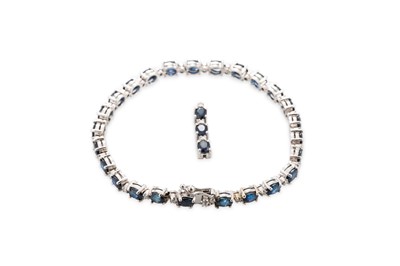 Lot 121 - A SAPPHIRE AND DIAMOND LINE BRACELET, the oval...