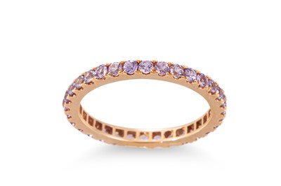 Lot 365 - A PURPLE SAPPHIRE FULL ETERNITY RING, mounted...
