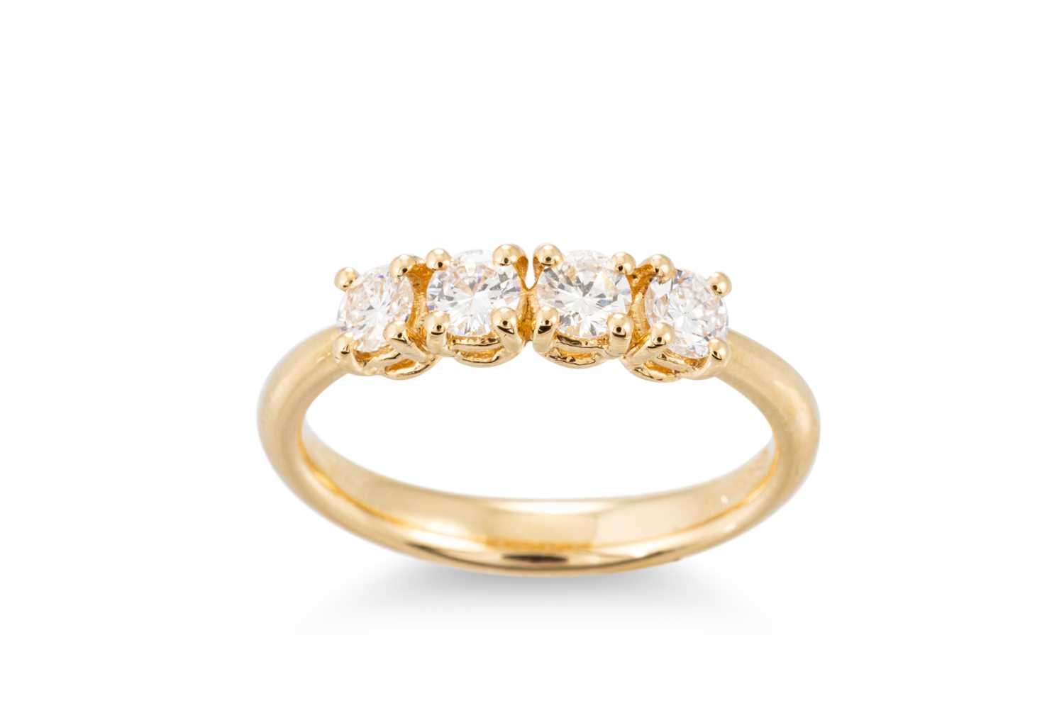 369 Ring Lot 369 - A DIAMOND FOUR STONE RING, mounted in 18ct