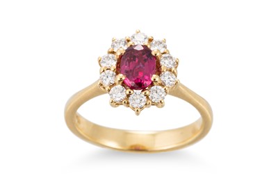 Lot 291 - A RUBY AND DIAMOND CLUSTER RING, the oval ruby...