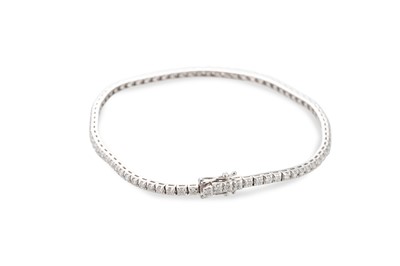 Lot 379 - A DIAMOND LINE BRACELET, mounted in 18ct white...