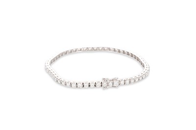 Lot 382 - A DIAMOND LINE BRACELET, mounted in 18ct white...