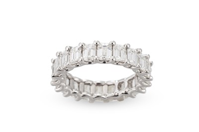 Lot 371 - AN EMERALD CUT DIAMOND ETERNITY RING, mounted...